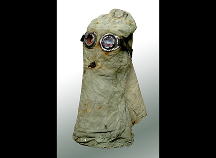 A hood made of cloth with a filtered hole for the mouth area and glass goggles for the eyes.