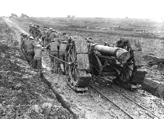 British soldiers moving big guns up to the front by hand