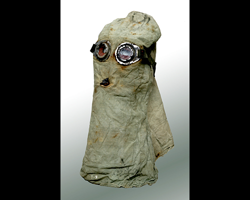 A hood made of cloth with a filtered hole for the mouth area and glass goggles for the eyes.
