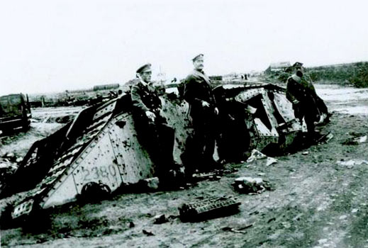 Photo of soldiers leaning against a disabled tank.