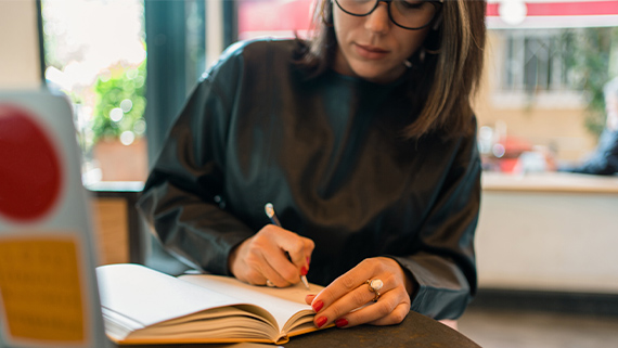 A person taking notes on their reading.