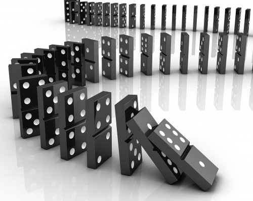 Dominoes falling to show cause and consequence