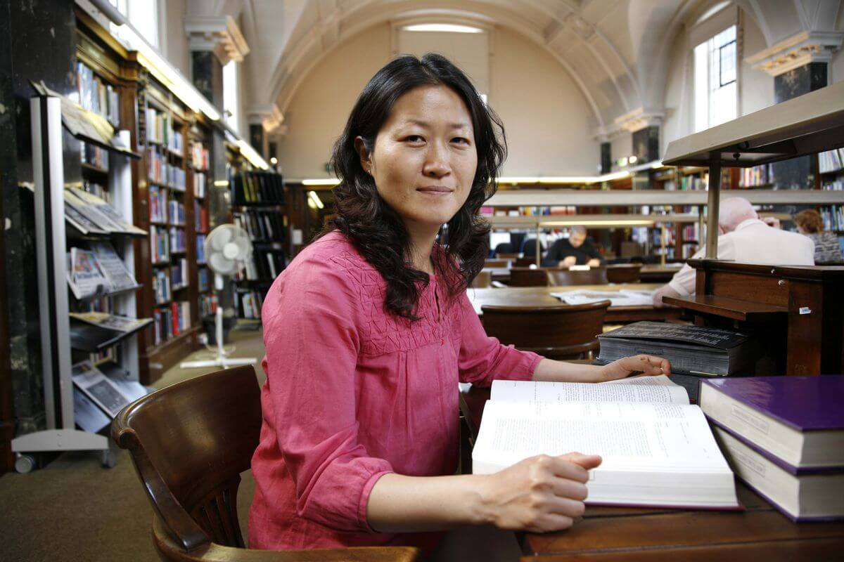 Image of people doing research in a library using secondary sources