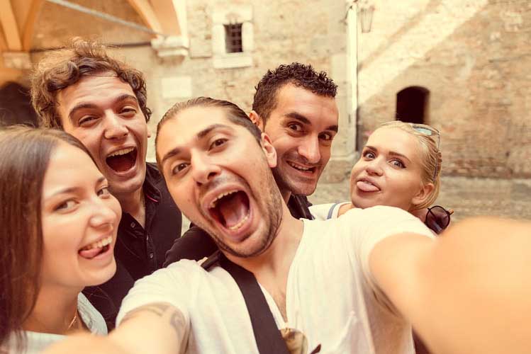 Young people taking a group selfie