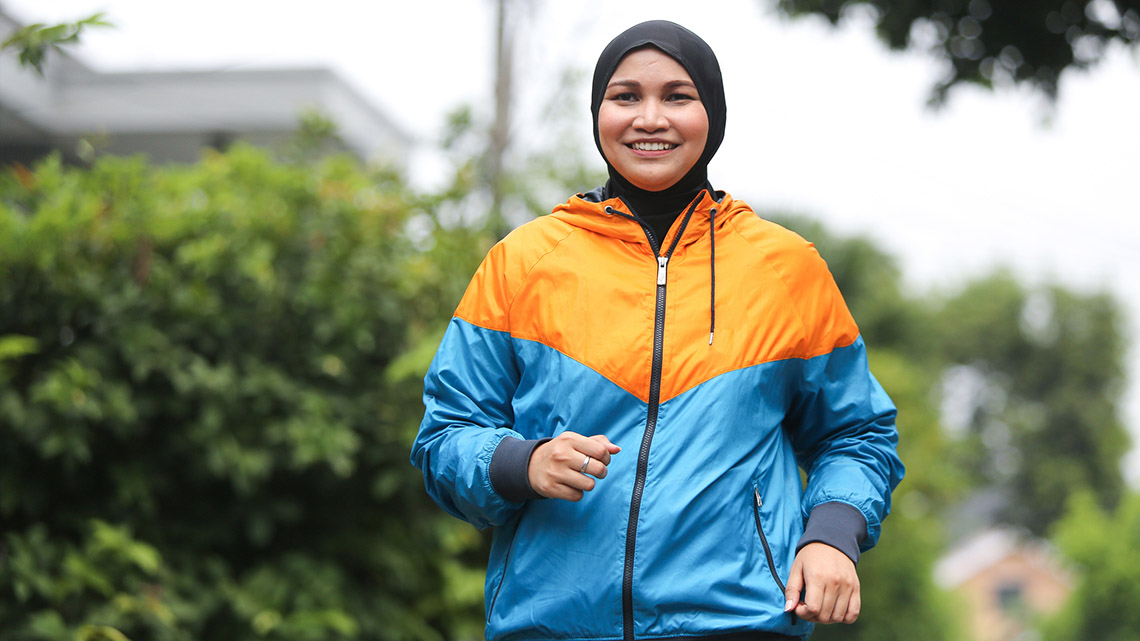 A person running with a happy and satisfied expression.