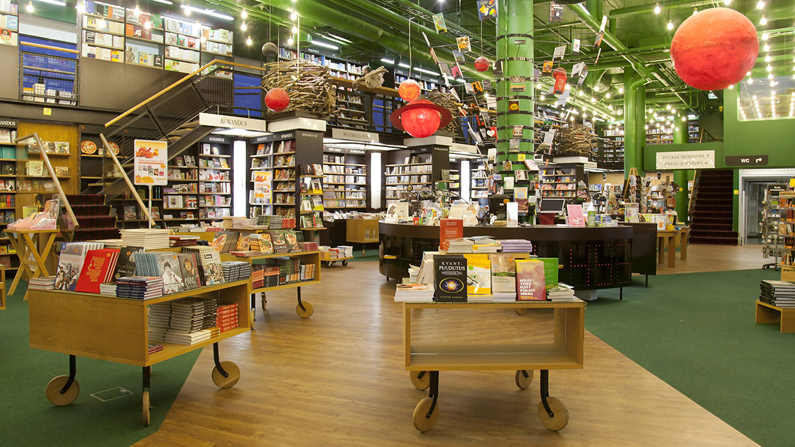 A spacious bookstore with lots of books on shelves and tables