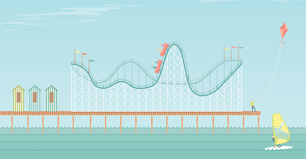 Roller-coaster on a seaside pier. The roller coaster track includes w and s shaped curves.