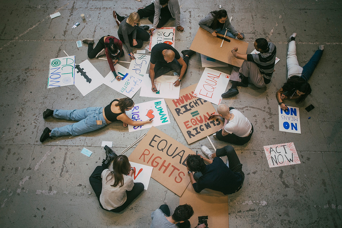 Group of individuals making protest banners