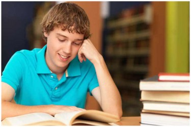 Young man reading a textbook