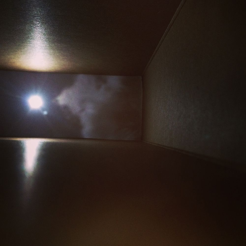 Sun and clouds projected on to the inner surface of a cereal box.