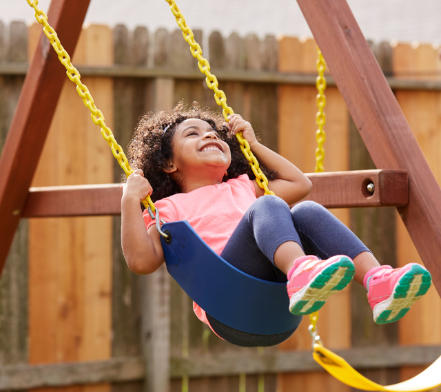 Girl on playground swing