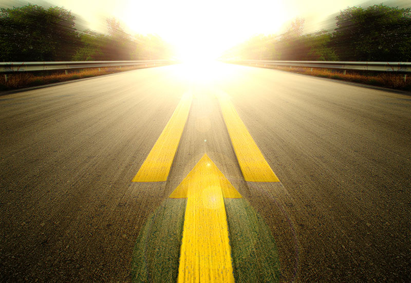 Road and yellow arrow illustrating speed.