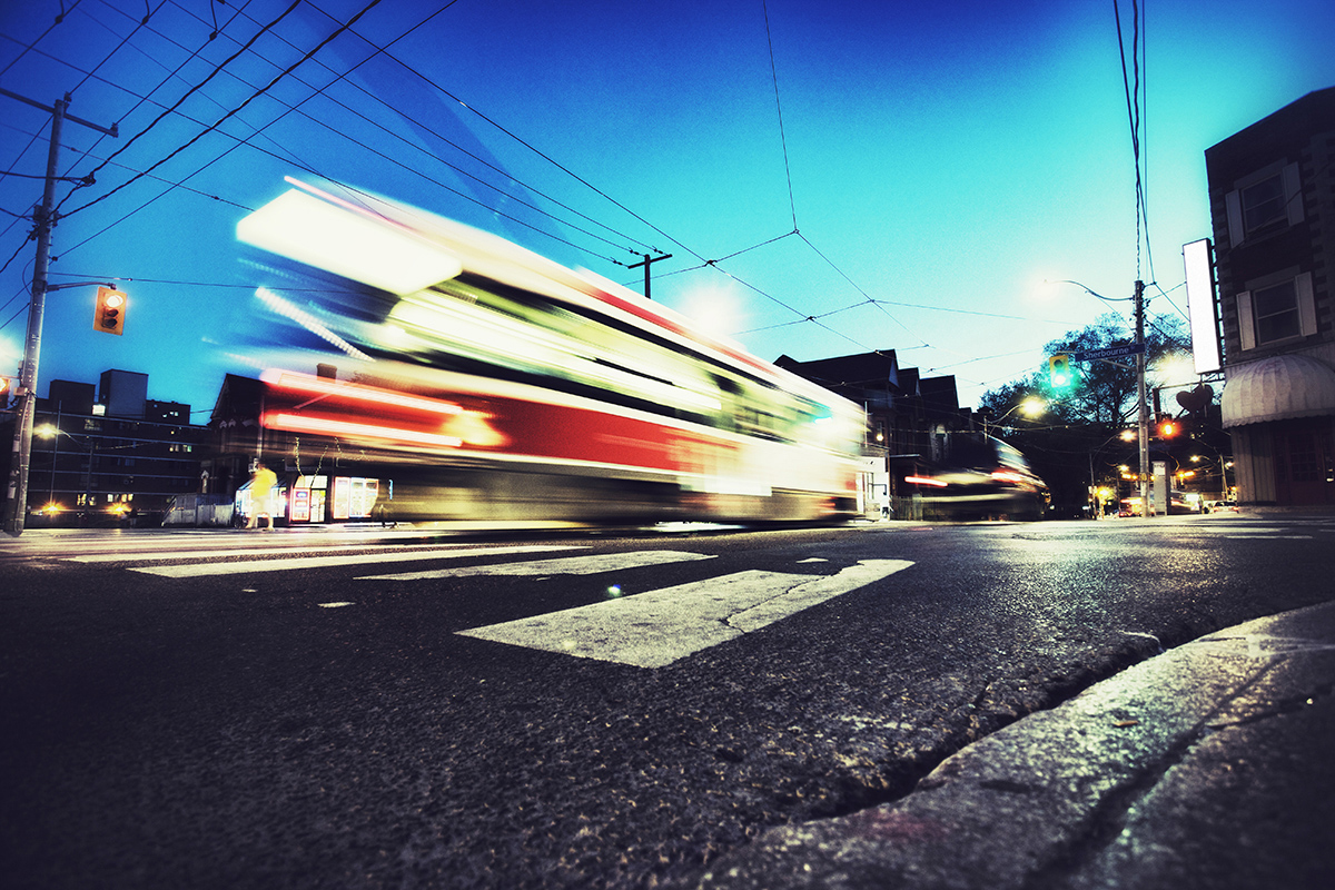 Double stacked container cars passing by railroad crossing