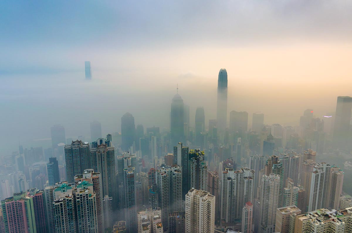 View of a city with smog covering it.