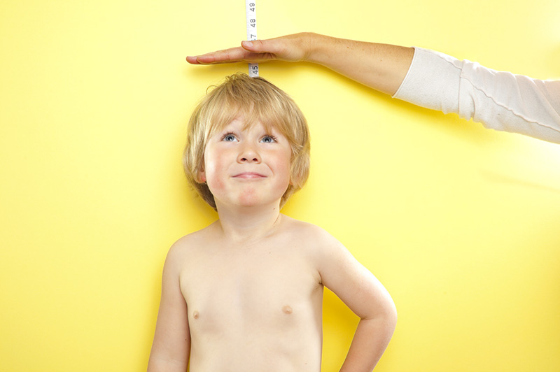 Young boy having his height measured
